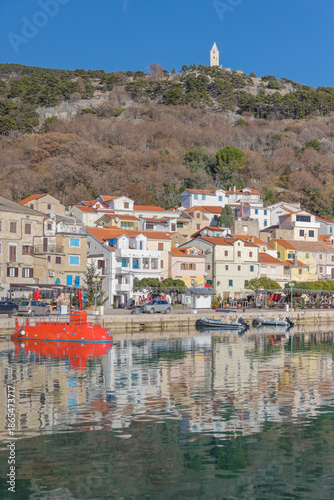 Baska harbor with red tourist submarine and boats