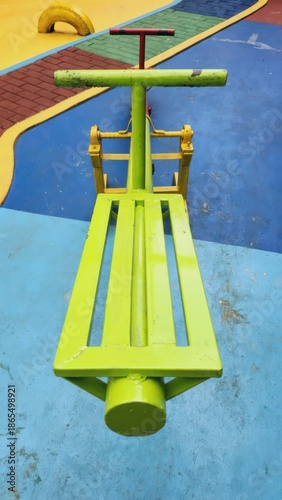 Yellow Playground Equipment on Blue Floor.