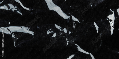Slika na platnu Black glossy wrinkled plastic texture with light reflection, abstract background