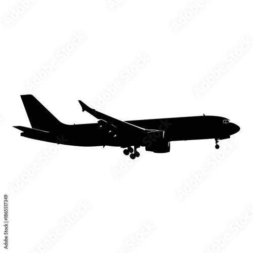 A silhouetted passenger airplane in flight showcasing its aerodynamic design