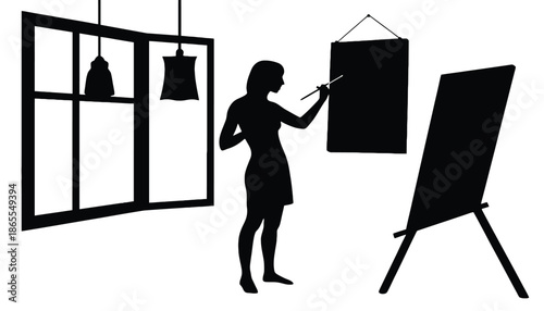 A woman in silhouette painting on a canvas in a modern studio