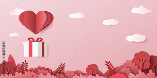 A paper heart balloon carrying a gift box against a pink background