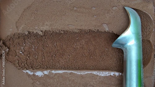 4K Chocolate ice cream with metal scoop creating rich texture and smooth surface, Concept of dessert frozen food chocolate flavor sweetness indulgence and minimal food background with copy space.