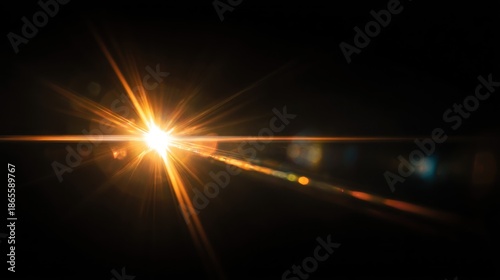 A brilliant, golden-orange light bursts forth from the center, radiating outward with numerous bright beams on a dark background