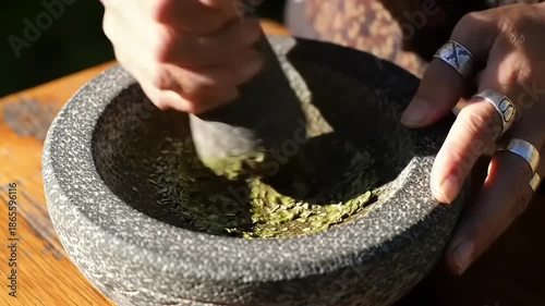 Grinding herbs in a mortar outdoors.
