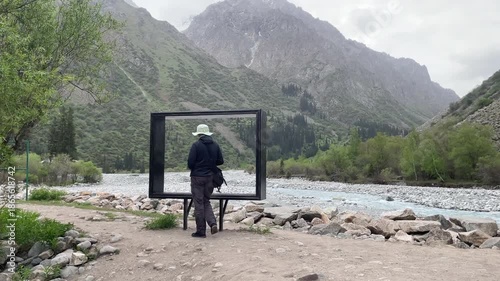 woman tourist posing for photo in mountains of kyrzystan