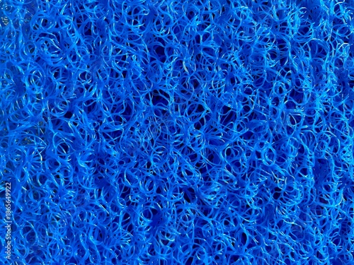 Foto Blue plastic mesh texture background with tangled synthetic fiber pattern