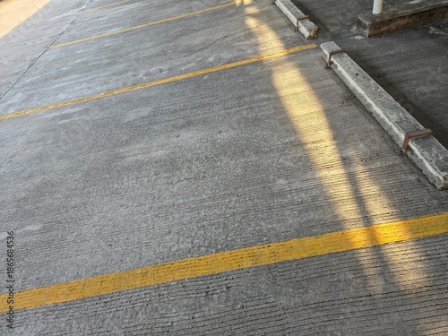 Fotografi Empty concrete parking lot with clear organizational markings