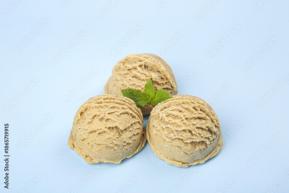Fototapeta premium Peanut Butter Ice Cream Scoops with Mint Garnish