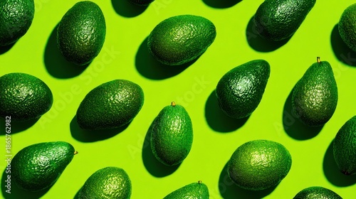 Bright green background features a pattern of whole avocados, each with a small stem