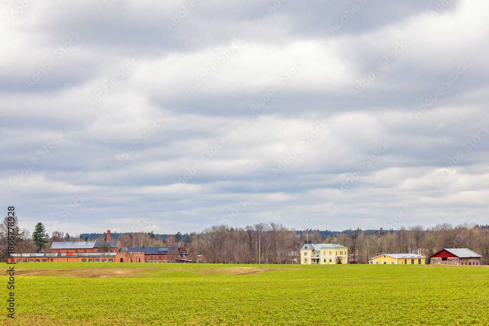 Obraz premium Old Industry in the countryside by a green field