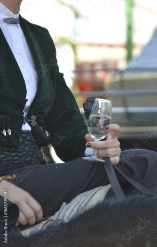 young woman drinking wine in the world famous Feria de abril, seville,  andalusia,  spain 