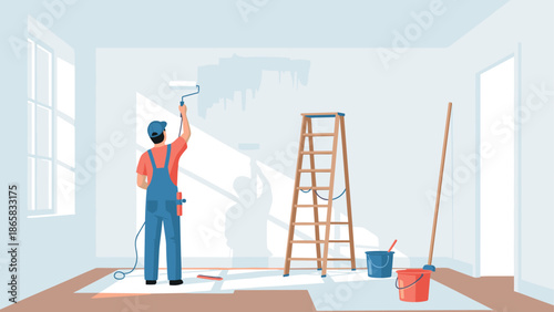 Home renovation with painter in overalls rolling fresh paint on wall