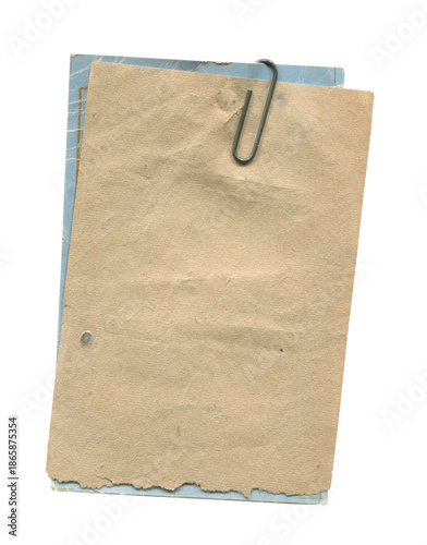 Stack of old paper tags clipped together with a metal paper clip  isolated on white