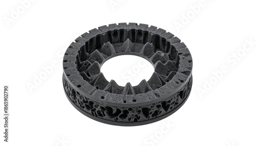 A complex, dark grey circular object with intricate internal patterns