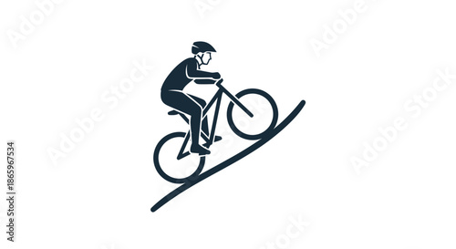 Silhouette of a Cyclist Riding Up a Steep Slope.