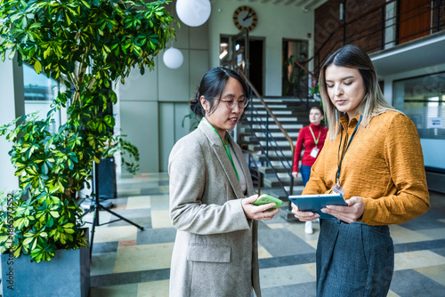 Teamwork and discussion in modern coworking office with digital devices