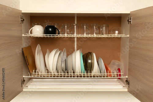 Open kitchen cabinet with dishes