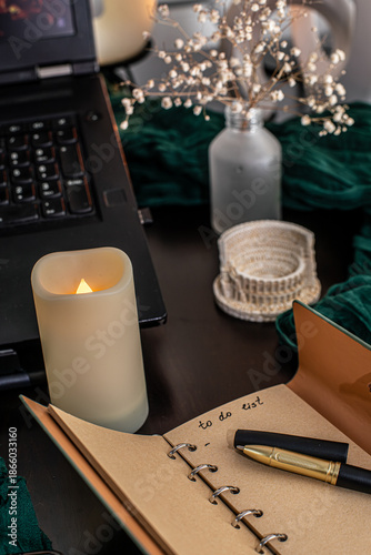 Cozy workspace with to-do list, coffee and candles – planning and mindfulness concept