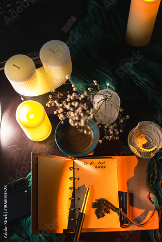 Cozy workspace with to-do list, coffee and candles – planning and mindfulness concept