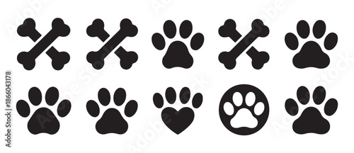 Collection of dog and cat pet icons featuring paw prints animal tracks crossed bones heart symbol and outline designs vector illustration set