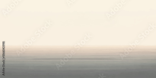A beautiful sunrise reflects over the calm ocean waves as misty morning fog drifts across the horizon under a light blue summer sky