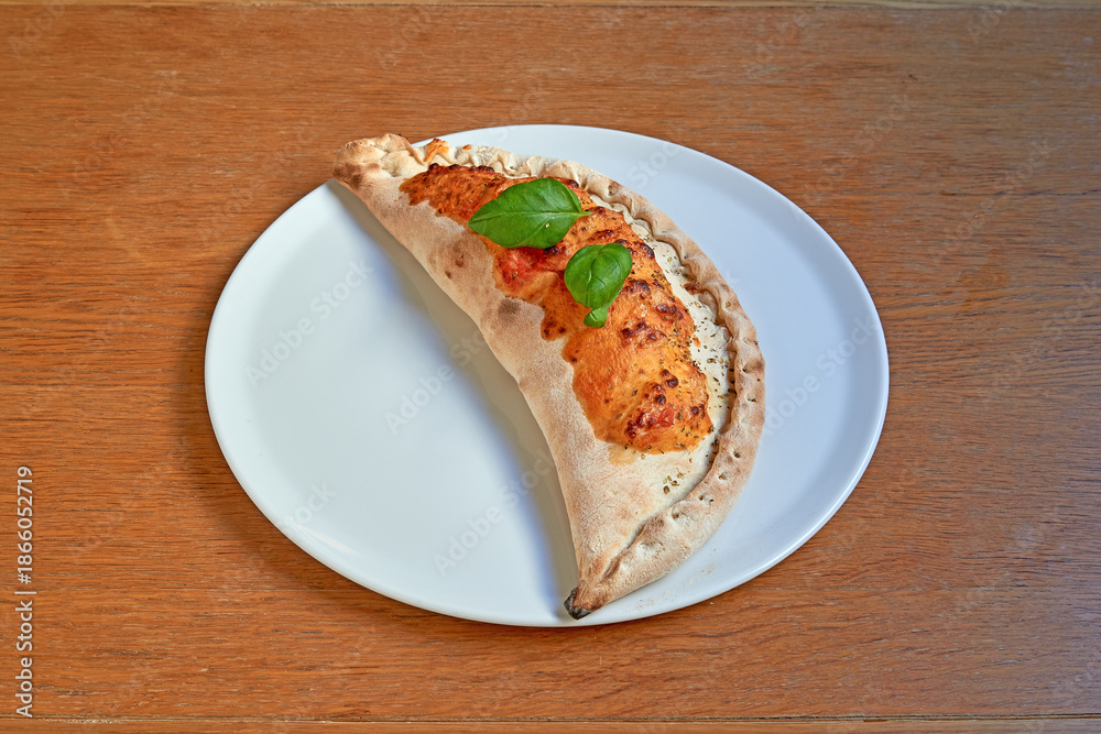 custom made wallpaper toronto digitalPizza Calzone on white plat on wooden table