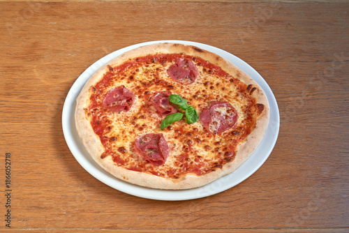 Wallpaper Mural Pizza Salami on white plat on wooden table Torontodigital.ca