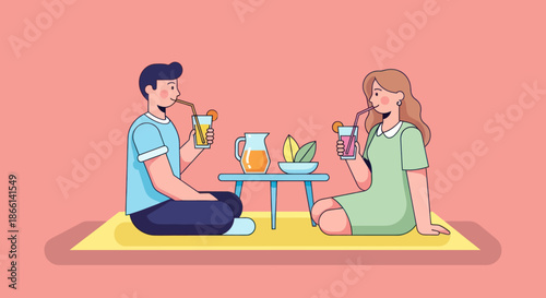 A couple enjoys a refreshing drink together during a picnic.