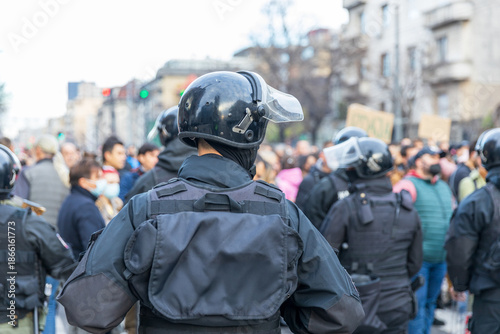 Riot police in winter city street protest, crowd control and public demonstration security © wellphoto