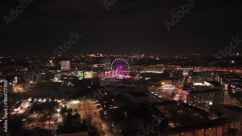 Wallpaper Mural Aerial drone video of Werksviertel-Mitte in Munich, Germany, at night. Illuminated Umadum Ferris wheel near Muenchner Ostbahnhof, festive city lights and modern skyline during New Years Eve Torontodigital.ca