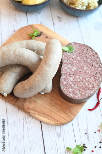traditional Czech pork sausages and blood pudding served as classic slaughterhouse specialties, Masopust cuisine, butcher products presented on a light background, authentic regional food concept,