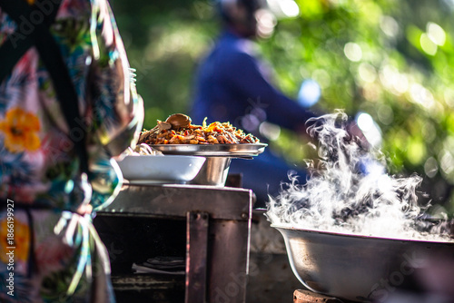 Vászonkép The backdrop of cooking smoke, illuminated by the beautiful morning sunlight, evokes the aroma of spices from the charcoal stove, and the delicious taste of kway chap, a favorite in tourist areas