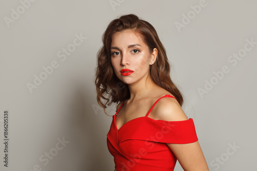 Perfect woman with long hair and make-up on white background. Gorgeous woman with curly hairstyle
