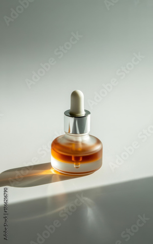 Minimalist skincare serum dropper bottle with amber oil on soft sunlit background clean beauty product mockup for cosmetic branding packaging label design ecommerce hero image and ads
