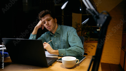Man mentally exhausted from continuous digital work. Concept of cognitive overload, reduced efficiency, need for breaks, sustainable productivity in technology-driven jobs.