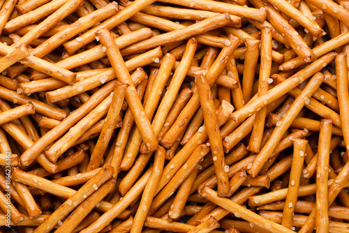 Pretzel sticks with salt background. Top view © innafoto2017