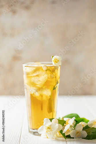 Jasmine green iced tea in a glass  on white wooden background
