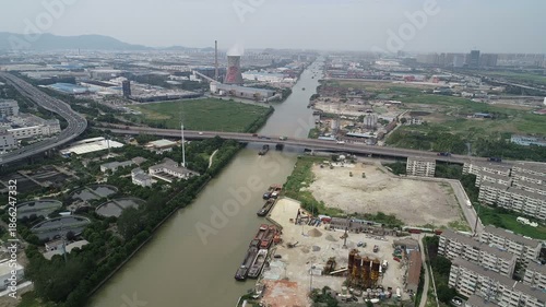 Drone flight over busy stretch of the historic Grand Canal in Suzhou, transportation and infrastructure in China
