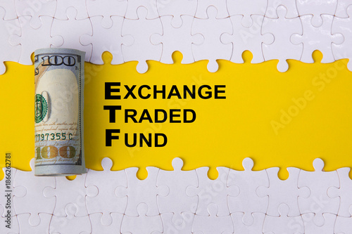 Etf exchange traded fund concept with money and puzzle