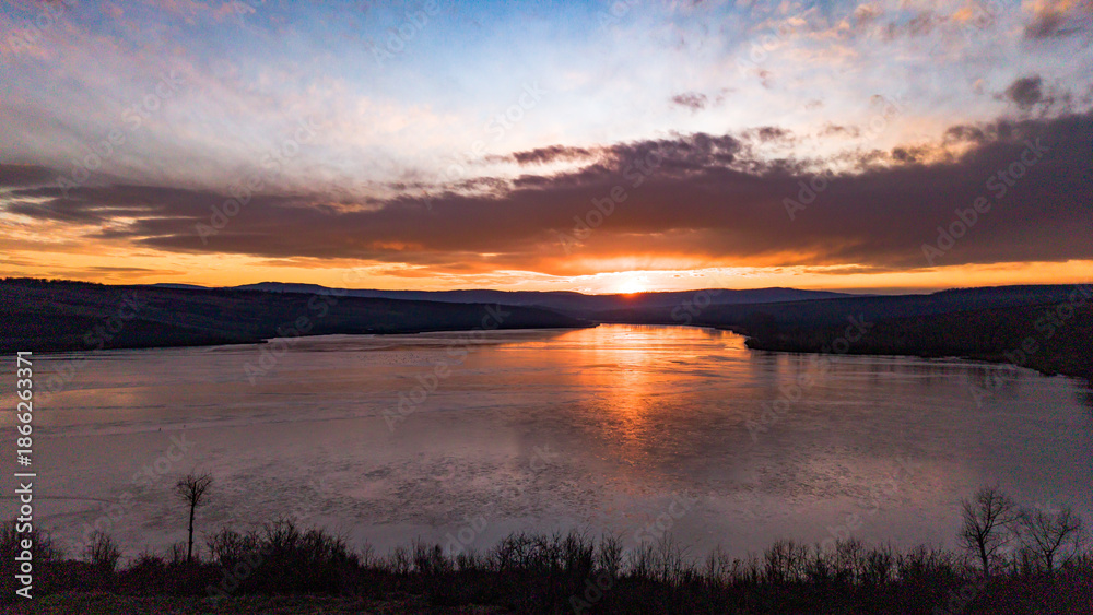 Obraz premium Aerial view over Dumbrava Lake in Iași, Romania, at sunset