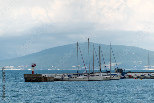July 28, 2025: Yacht parking along the waterfront in Novorossiysk, Russia, with moored yachts near the coastline, reflecting maritime life and the Black Sea harbor atmosphere