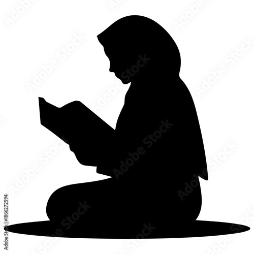 Silhouette of a Muslim woman reading the Quran.