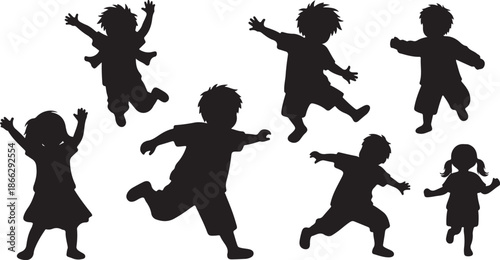 Silhouettes of happy children jumping and playing together outdoors
