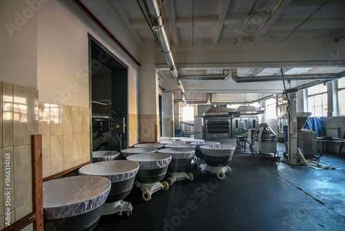 Industrial Bakery Interior with Dough Mixing Bowls and Baking Equipment