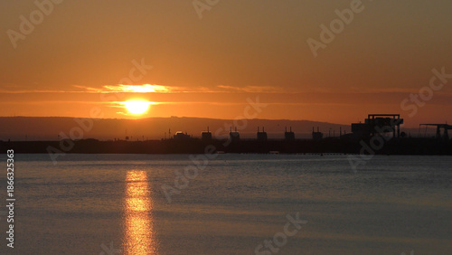 Calm Morning Sunrise over Cardiff Bay showing still water and the Barrage