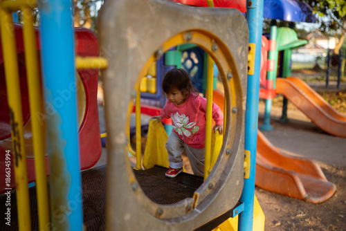 Tableau sur toile Climbing and Exploring: Toddler Navigating the Playground Structure