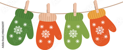 Colorful winter mittens hanging on a clothesline with snowflakes