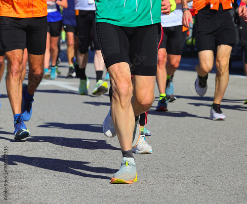 Billede på lærred running shoes and legs also with sporty leggings with many male and female amate