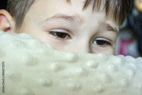 Extreme close-up of a little boy's brown eyes looking at the camera.